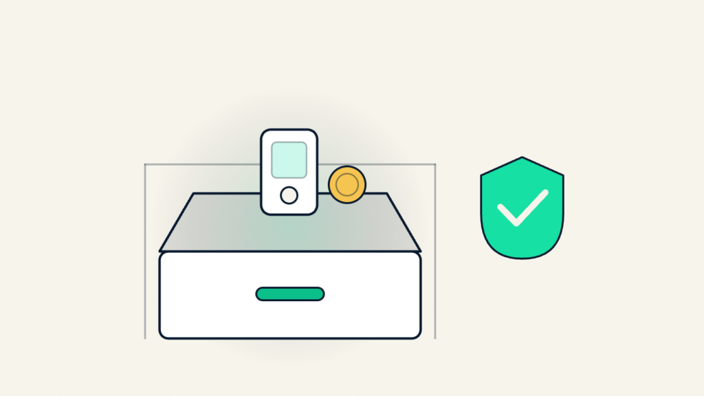 A small hardware device and a coin resting on an open drawer beside a shield